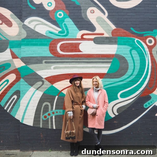 Top London Walls for Studio DIY and Urban Photography 11 Two people standing in front of a colorful mural