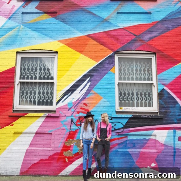 Top London Walls for Studio DIY and Urban Photography 12 Two people standing in front of a colorful mural