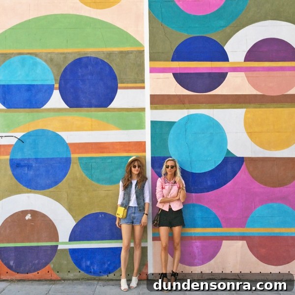 Top London Walls for Studio DIY and Urban Photography 8 Two people standing in front of a colorful mural