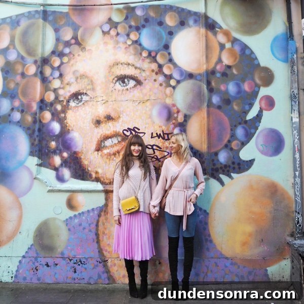 Top London Walls for Studio DIY and Urban Photography 9 Two people standing in front of a colorful mural