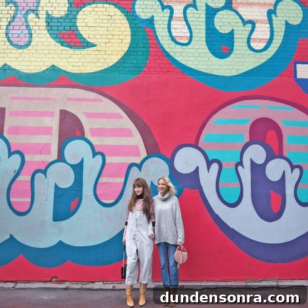 Top London Walls for Studio DIY and Urban Photography 10 Two people standing in front of a colorful mural