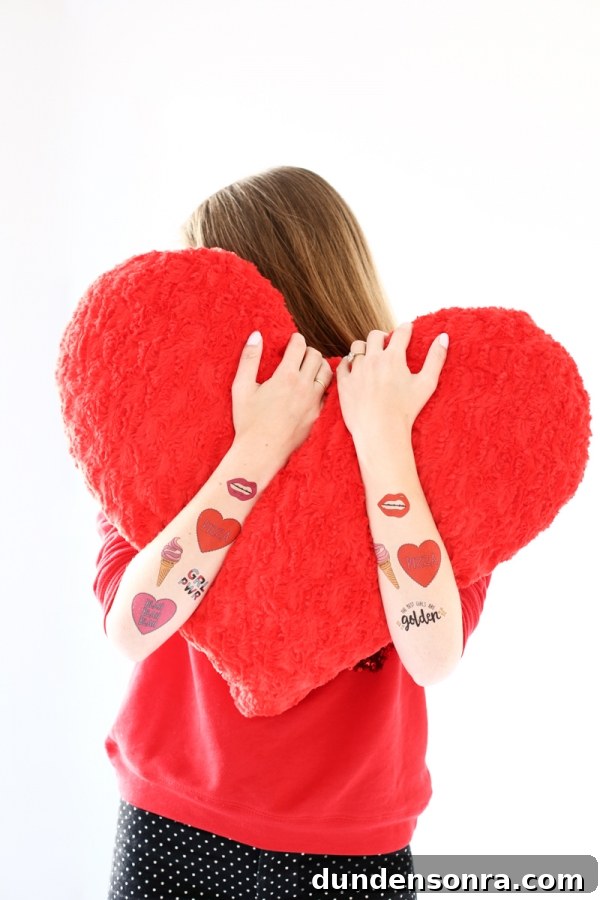 Someone holding a red heart pillow