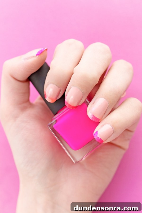 Someone holding hot pink nail polish