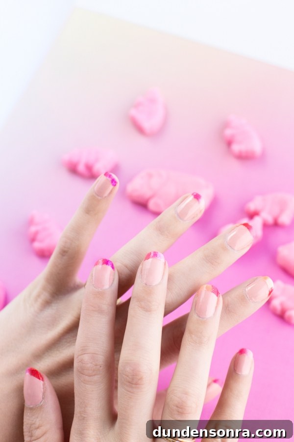 Hands with pink nail polish on it