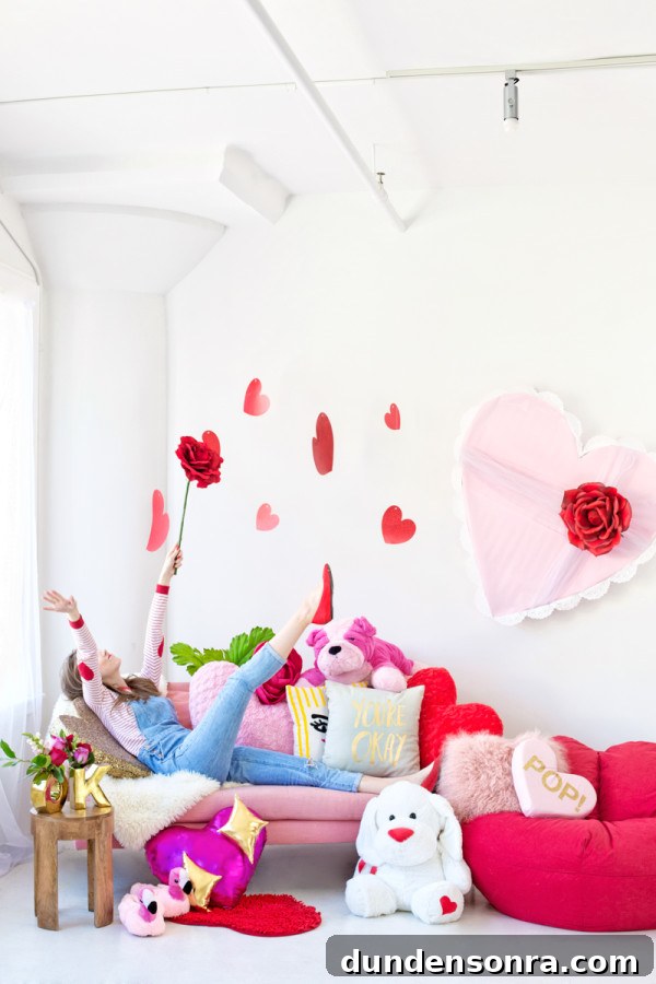 Galentine’s Day Slumber Party Throwback with Free Printables 16 Someone sitting on a couch with a bunch of pillows