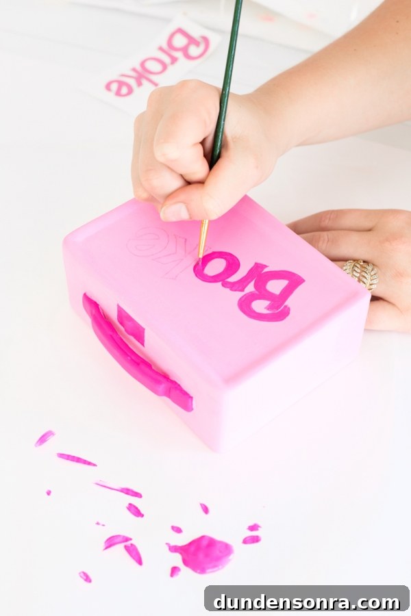 Someone painting a box