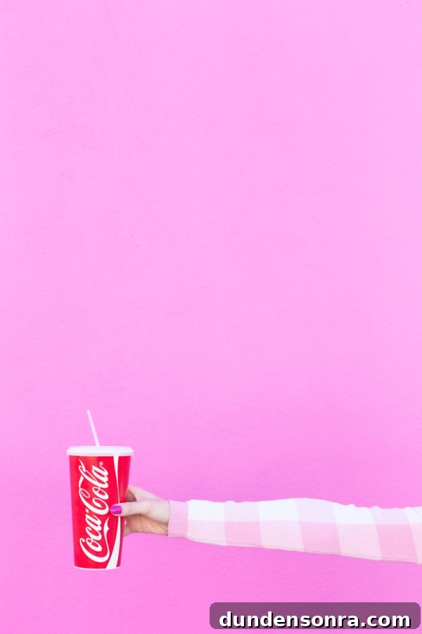 3 Stylish Ways to Wear Light and Monochrome Outfits 4 A woman holding a coca cola cup
