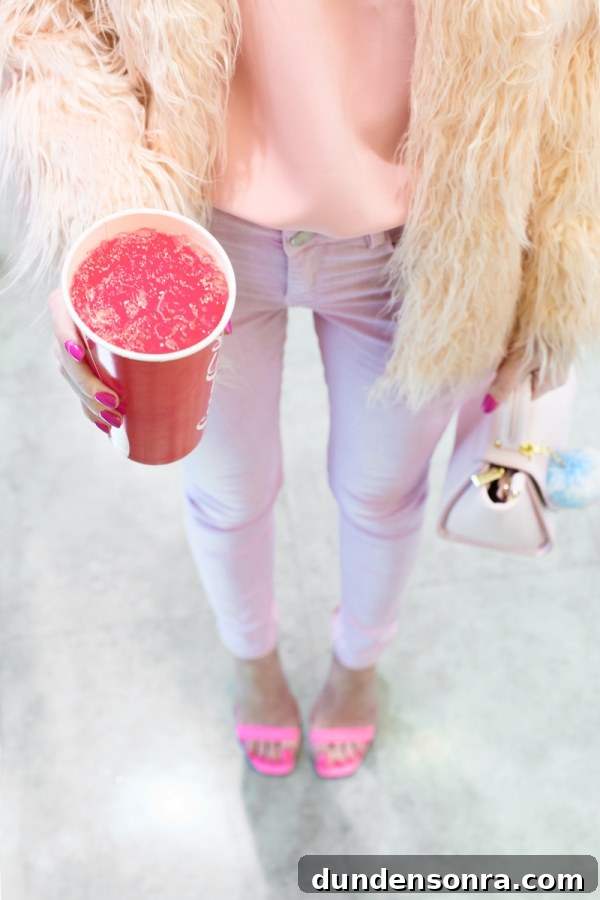 3 Stylish Ways to Wear Light and Monochrome Outfits 7 A woman wearing pink pants and holding a pink drink