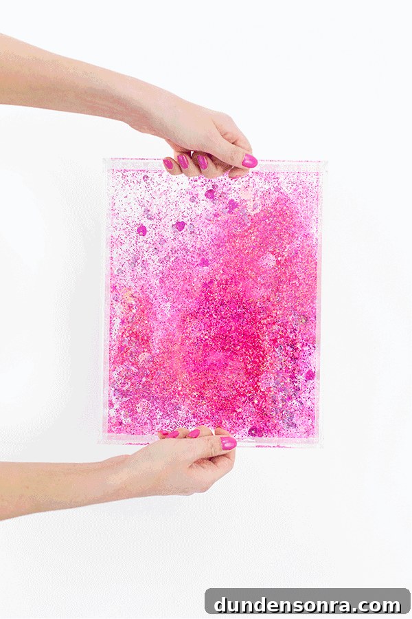 Make Your Own Sparkling Resin Glitter Tray: Simple DIY Guide 3 Someone holding a pack of pink glitter