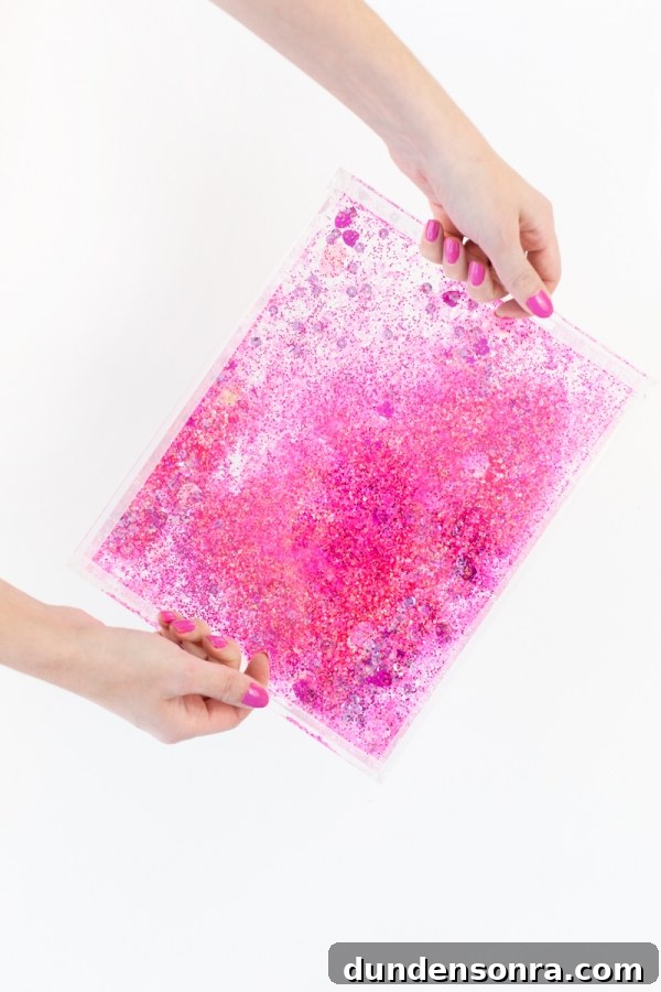 Make Your Own Sparkling Resin Glitter Tray: Simple DIY Guide 9 Someone holding a plastic bag with pink glitter