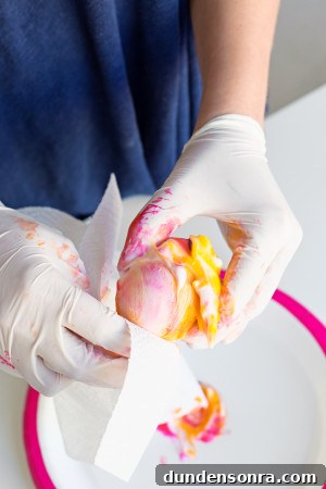 DIY Lisa Frank Easter Eggs: Vintage-Inspired Colorful Egg Ideas 7 Someone holding a colorful egg
