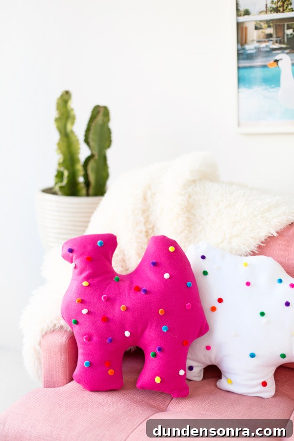 Circus animal cookie pillows on a pink couch