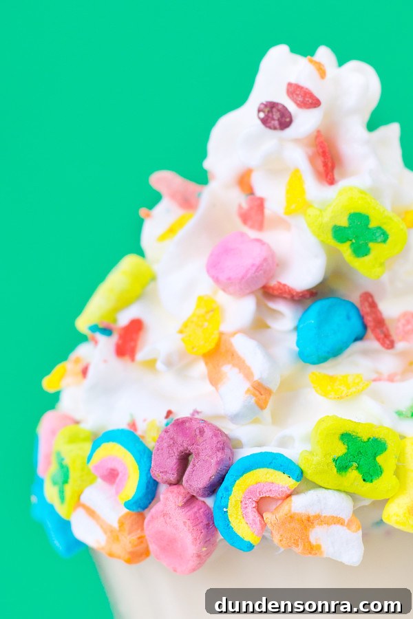 Colorful Rainbow Cereal Milkshake Recipe for Kids and Parties 3 Whip cream with lucky charms on it