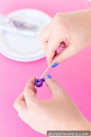 Someone holding a purple "P" candle