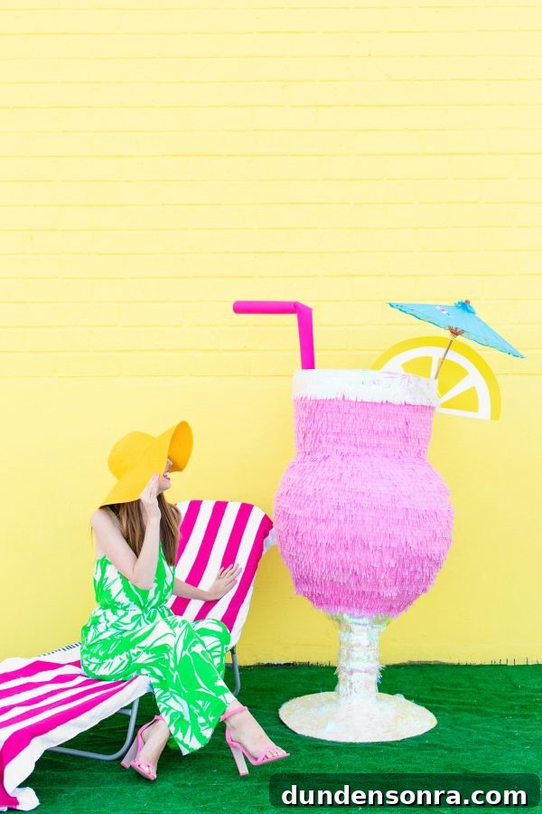 DIY Tropical Drink Piñata Tutorial: How to Make a Pineapple Party Piñata 2 A woman and a pinata