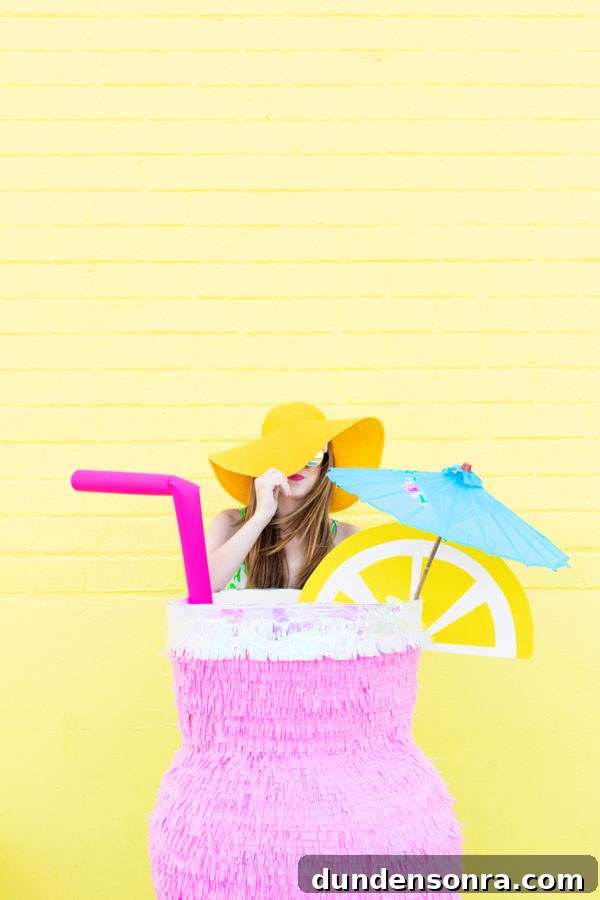 DIY Tropical Drink Piñata Tutorial: How to Make a Pineapple Party Piñata 8 A woman and a Piñata