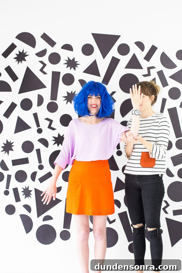 People in front of a wall with black shapes