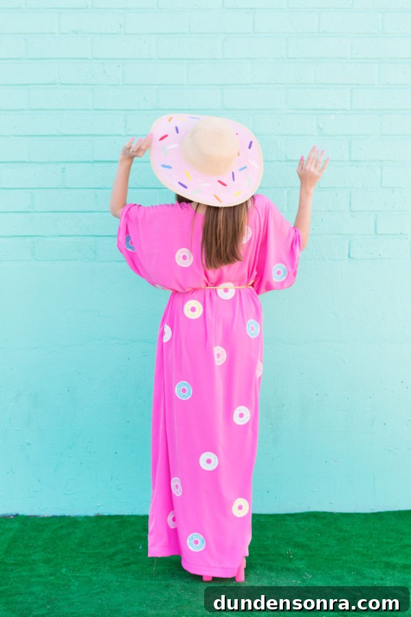 A woman wearing a pink dress with donuts on it