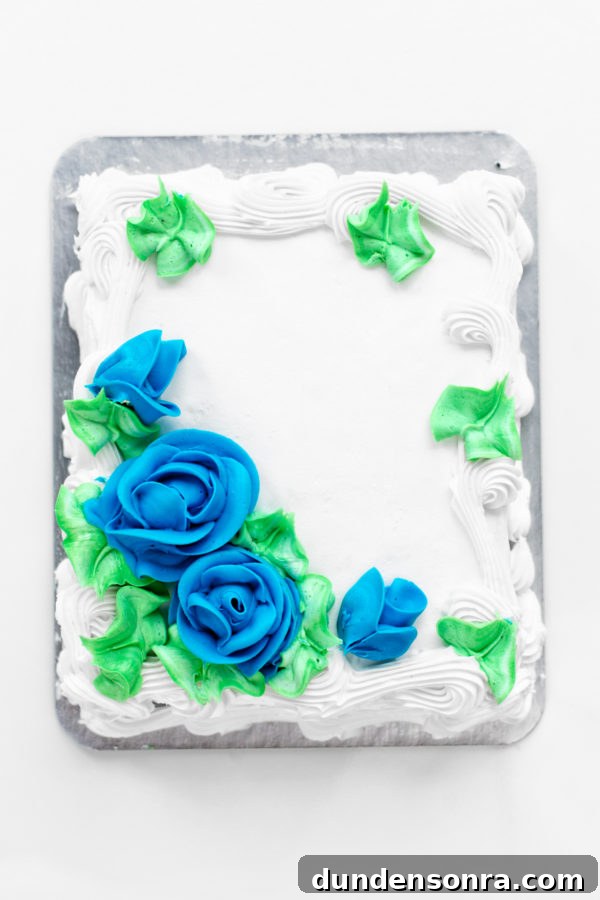 Cakeover: 6 Clever Store-Bought Cake Decorating Hacks 8 A white cake with blue flower frosting