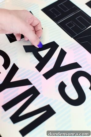 Someone putting black letters on a surface