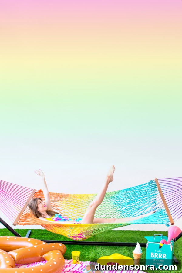 A woman sitting in a rainbow hammock 