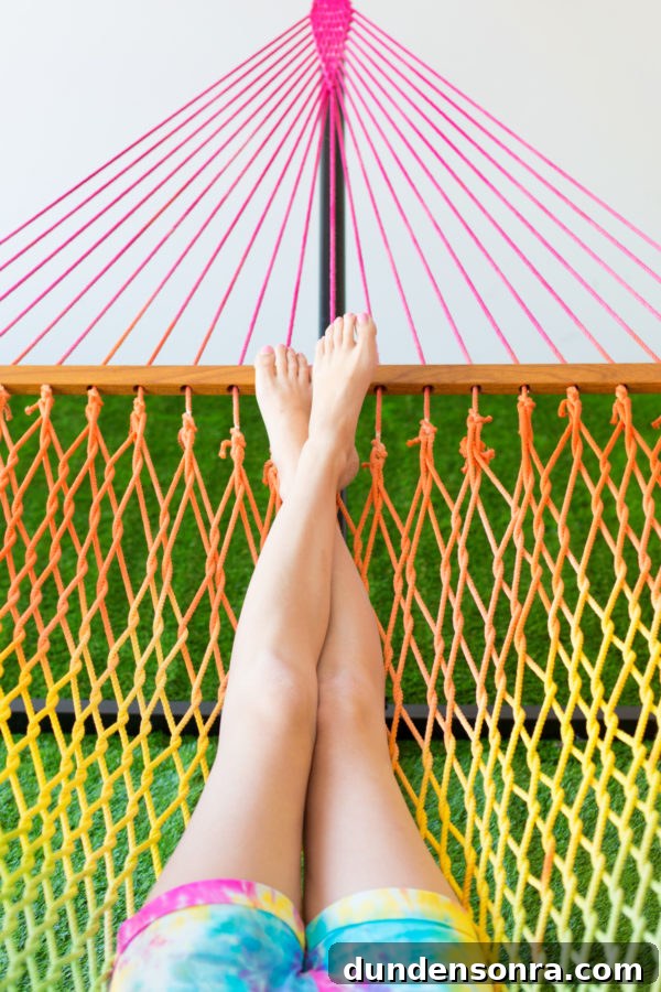 Someone sitting in a rainbow hammock