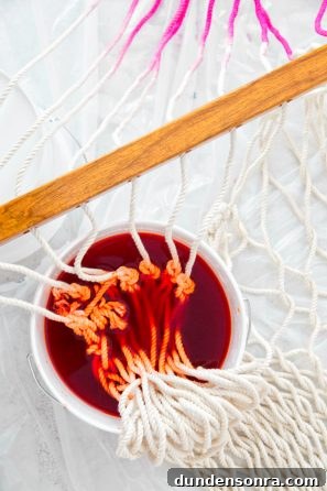 Someone dying the strings of a hammock red