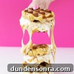 Someone holding waffle sandwiches
