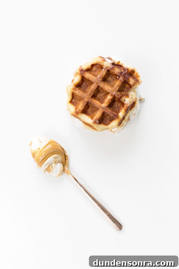 A waffle and a spoon with food
