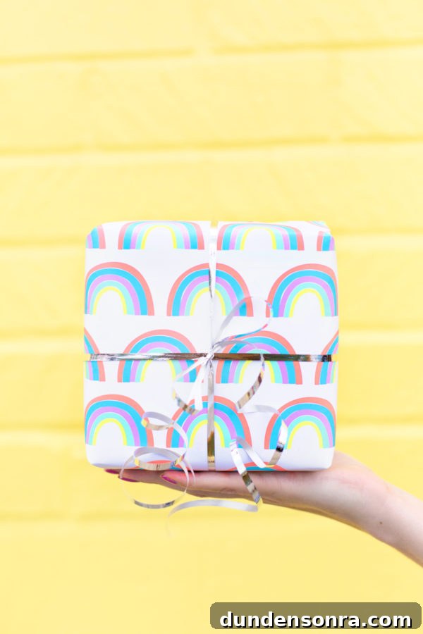 Someone holding a present in front of a yellow wall