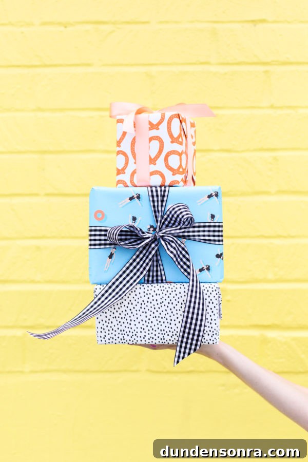 Someone holding presents in front of a yellow wall