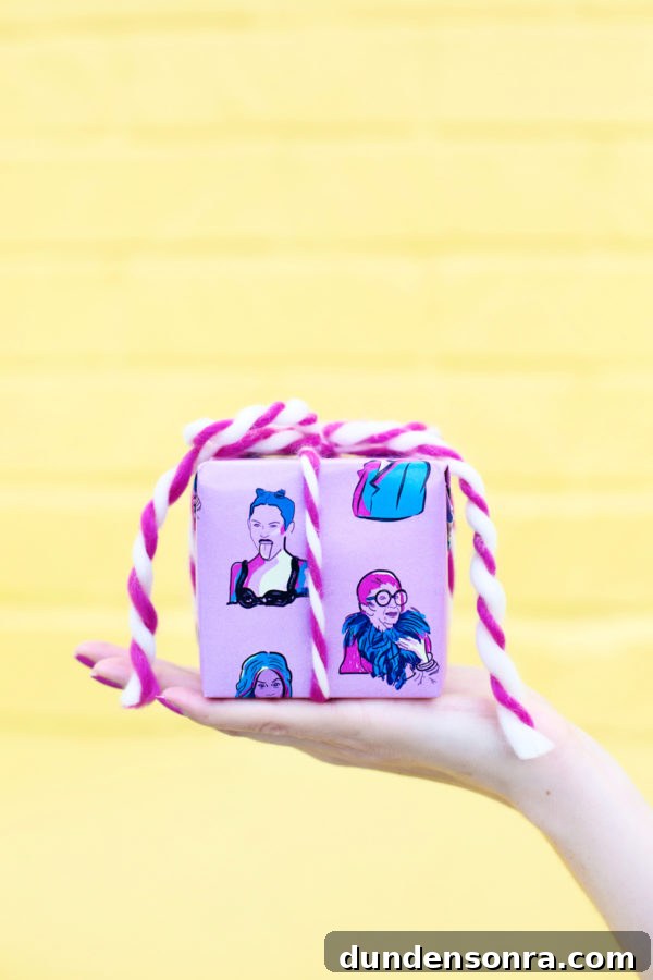 Someone holding a present in front of a yellow wall