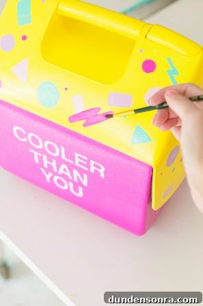 Someone painting a cooler pink and yellow