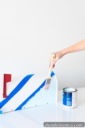 Someone painting a mailbox