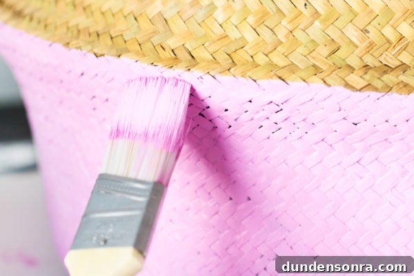 DIY Painted Graphic Laundry Baskets: Step-by-Step Guide for Stylish Storage 7 Paint brush and pink laundry basket