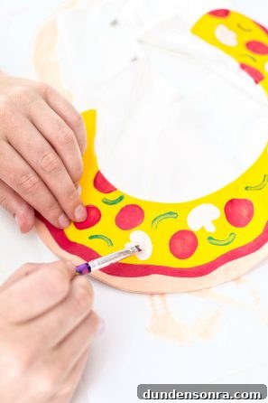 How to Make a Pizza Collarette at Home: Step-by-Step Guide 11 Someone painting pizza on a collar