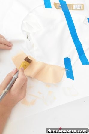 Someone painting fabric beige 