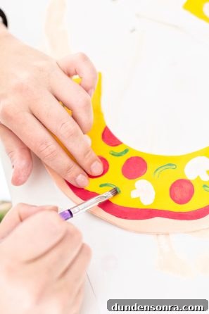 Someone painting pizza on a collar