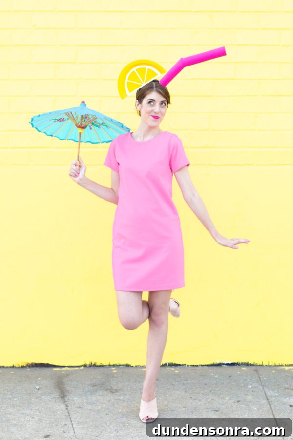 A woman in a tropical drink costume in front of a yellow wall