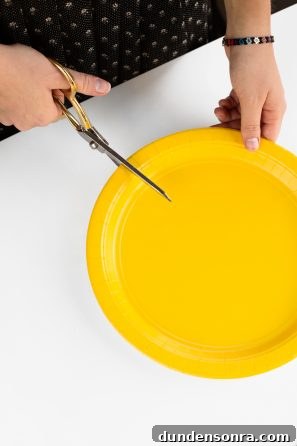 Someone cutting a yellow plate