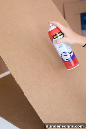 Someone spraying cardboard 