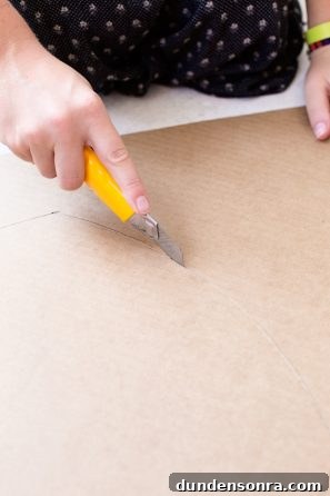 Someone cutting cardboard