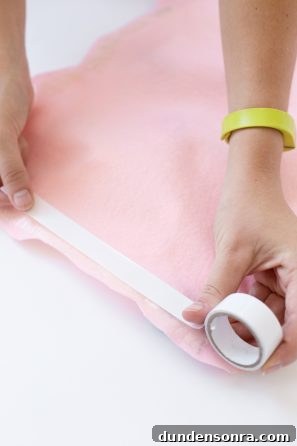 Someone taping pink fabric