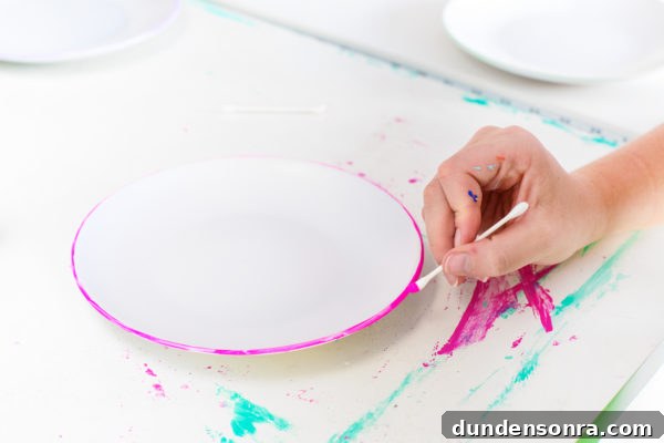 DIY Dessert Plates with Color-Edged Trim: Step-by-Step Guide 5 Someone painting a plate