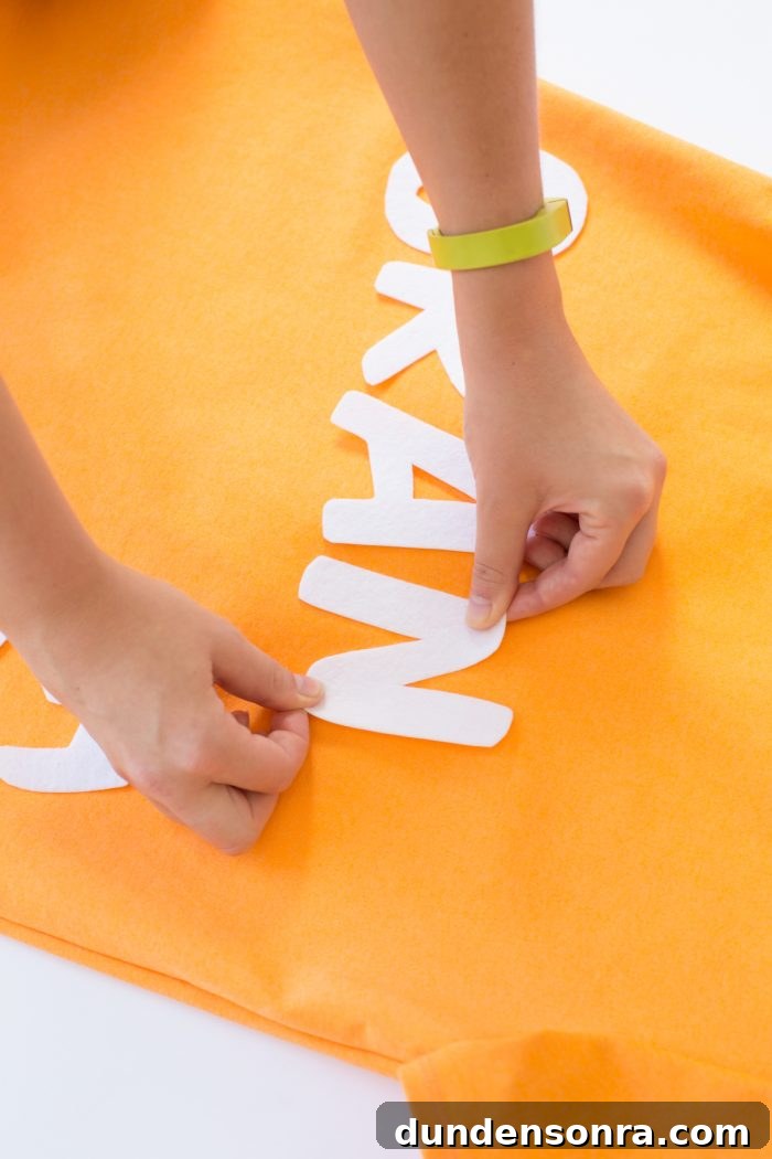 White-letter cut-outs on orange fabric