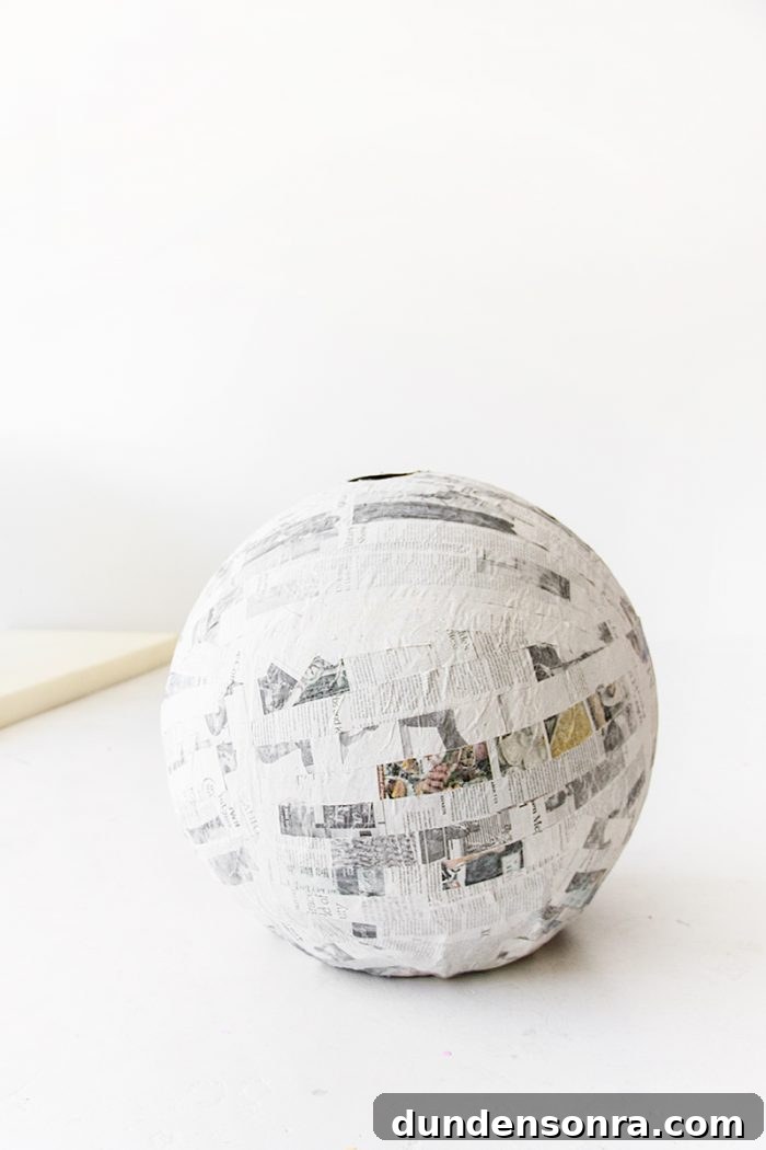 A ball with newspapers glued on it