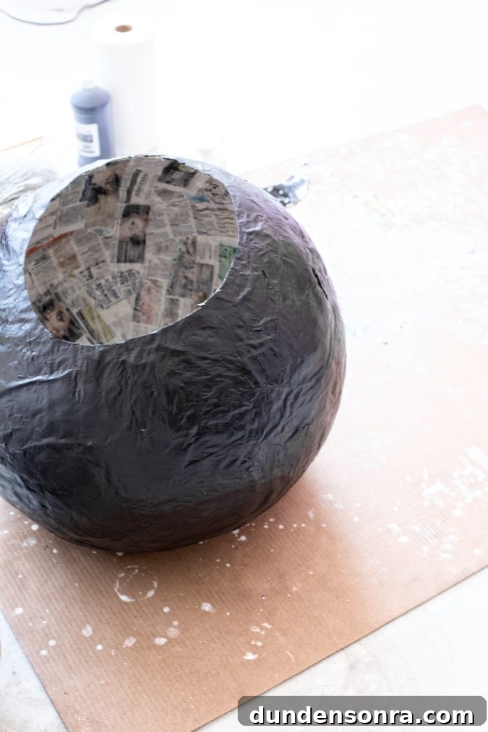 A newspaper ball painted black