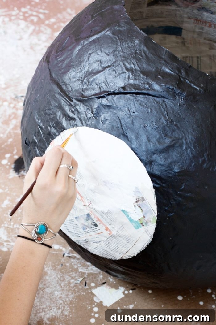 Black newspaper wall with white paint