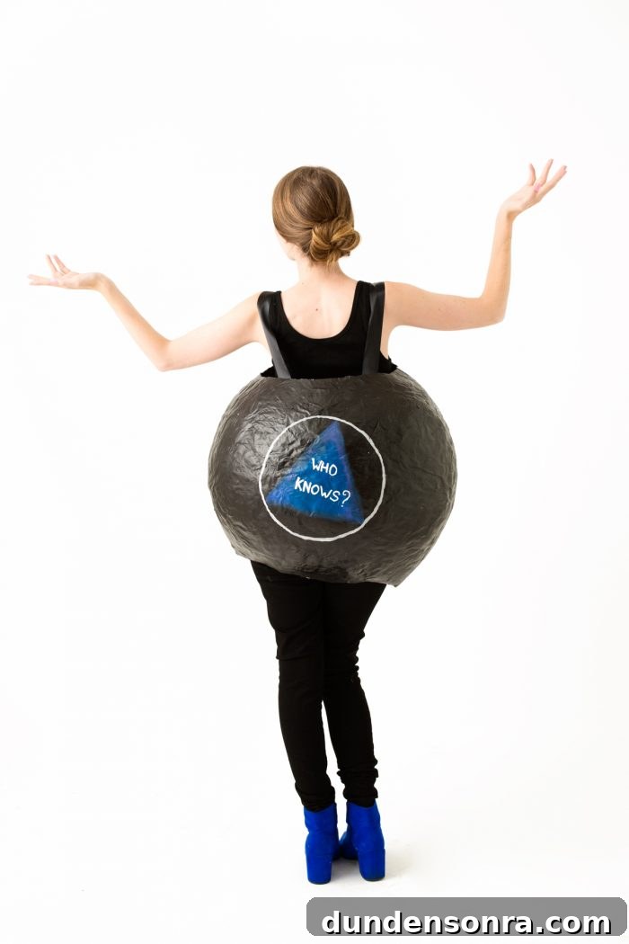 A woman wearing an eight ball costume 