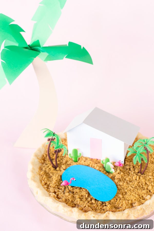 A pie with a miniature house and trees on it